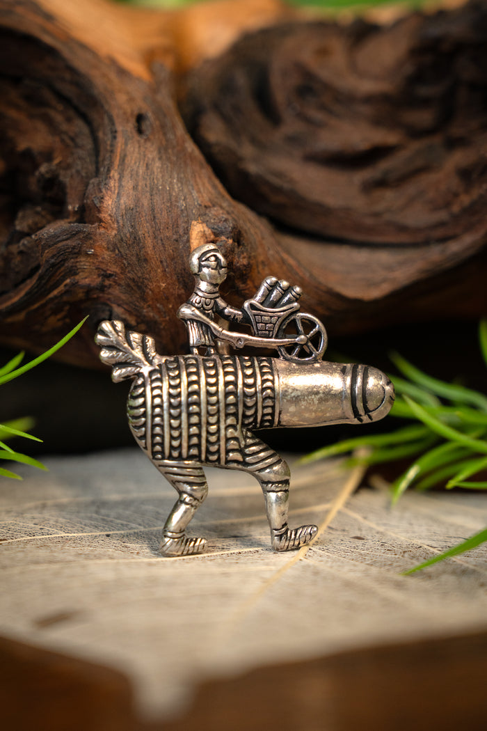 Pilgrim badge phallus with wheelbarrow, silvered bronze