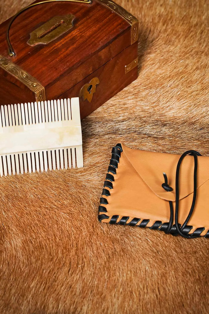 Medieval bone comb with leather bag
