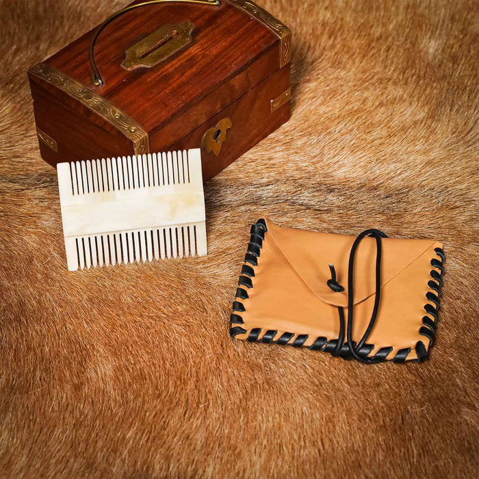 Medieval bone comb with leather bag