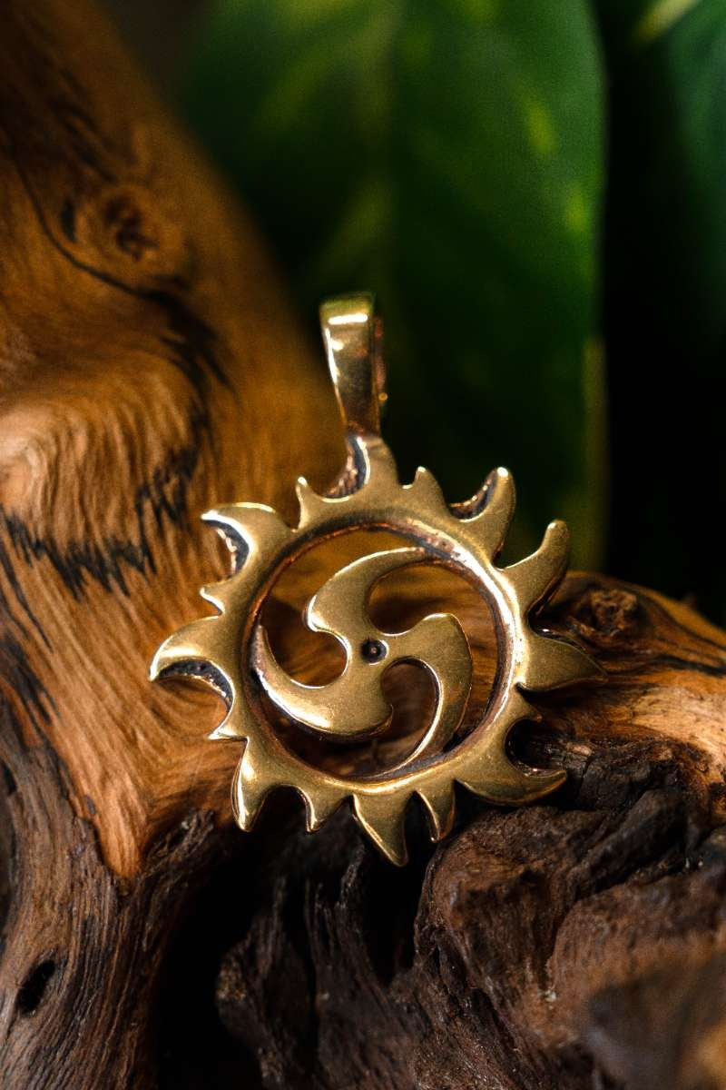 Pendant triskelion with sun, bronze