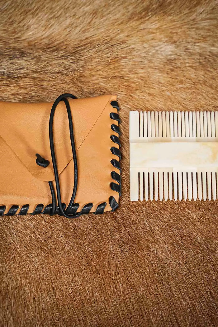 Medieval bone comb with leather bag