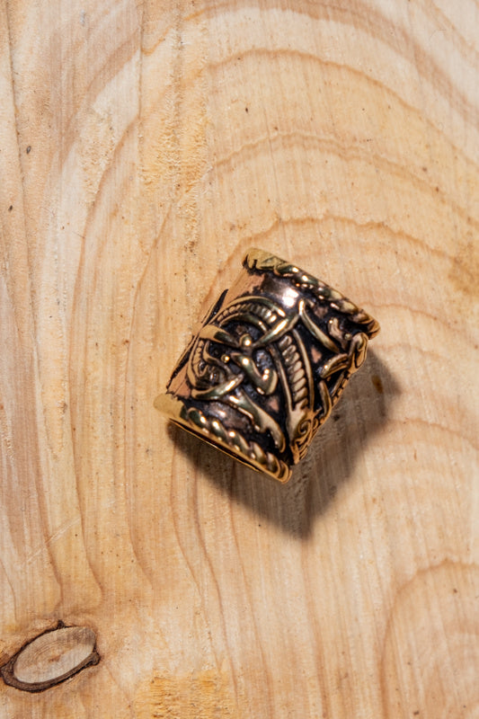 Viking beard bead with dragon motif, bronze