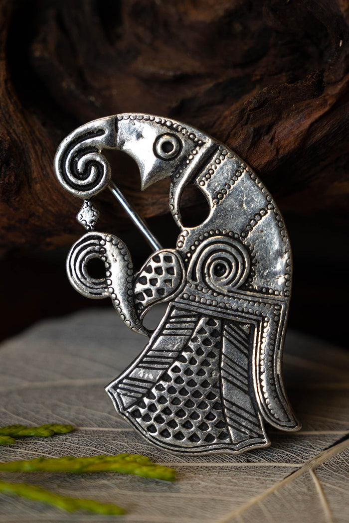 Vendel raven brooch Gotland, left, silvered bronze
