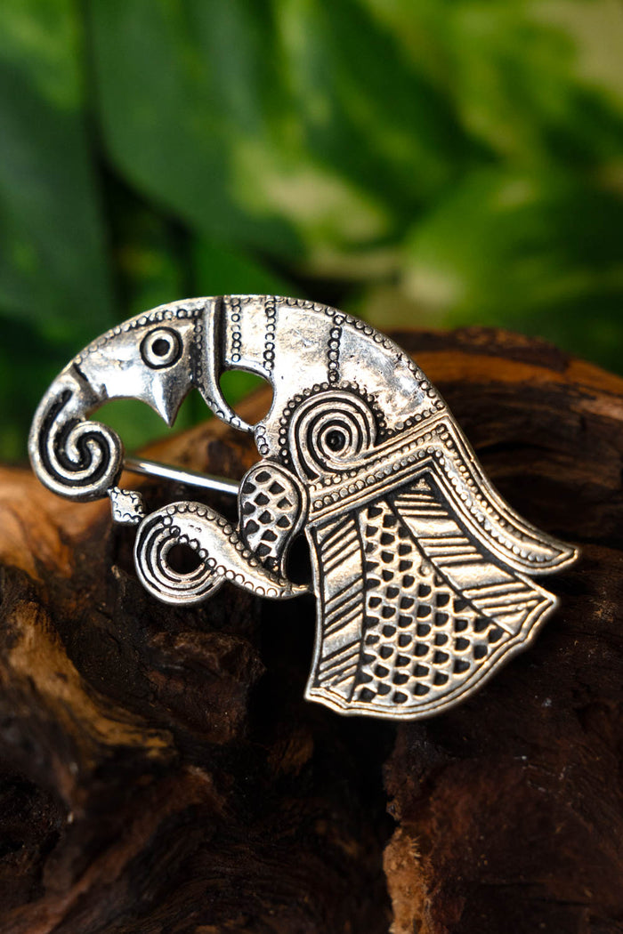 Vendel raven brooch Gotland, left, silvered bronze