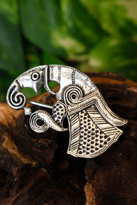Vendel raven brooch Gotland, left, silvered bronze