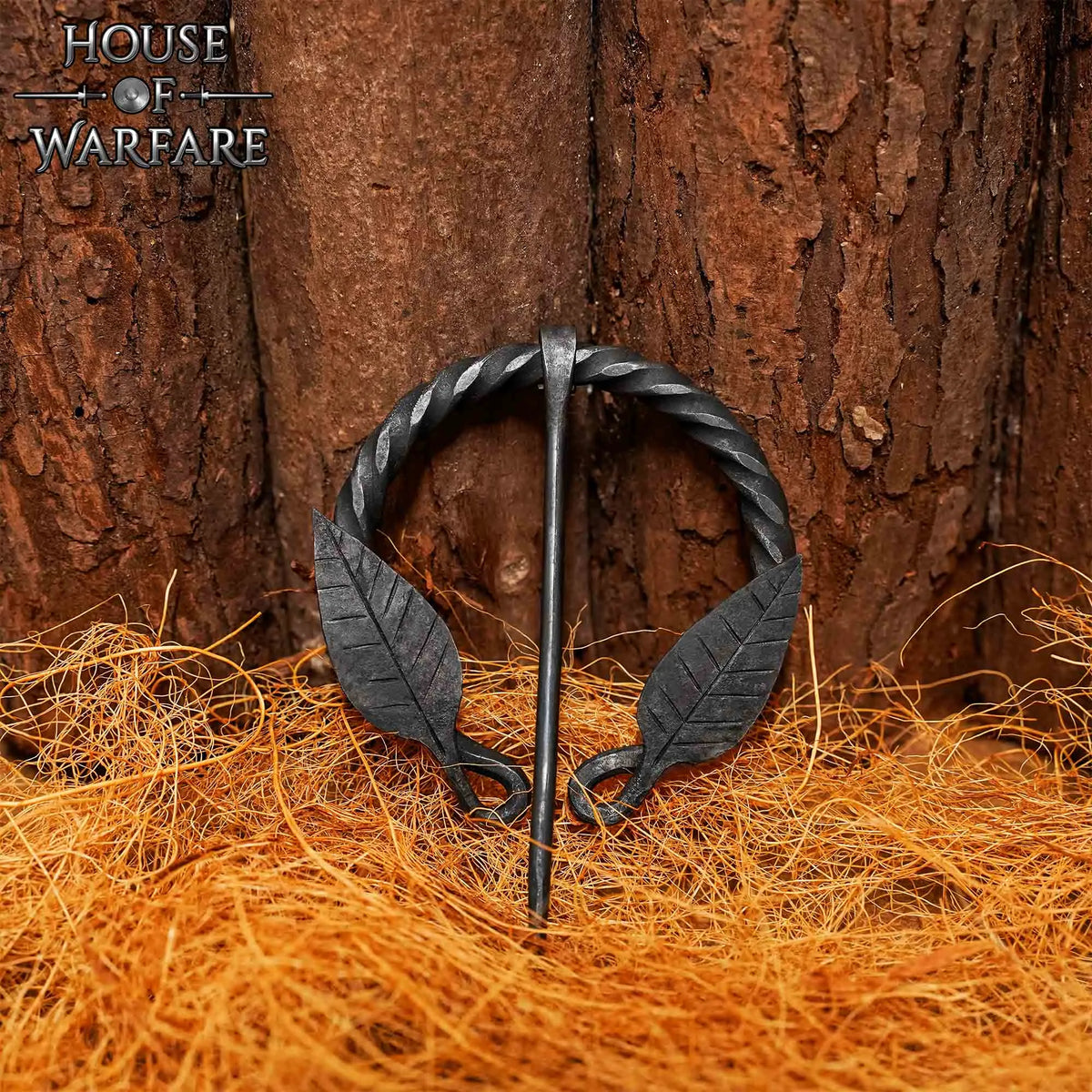 Twisted horseshoe fibula with leaf motif, iron