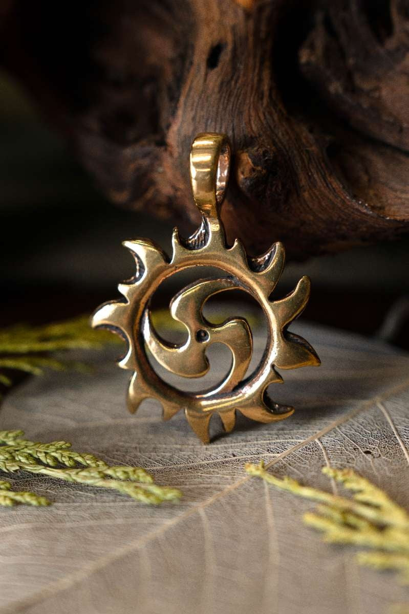 Pendant triskelion with sun, bronze