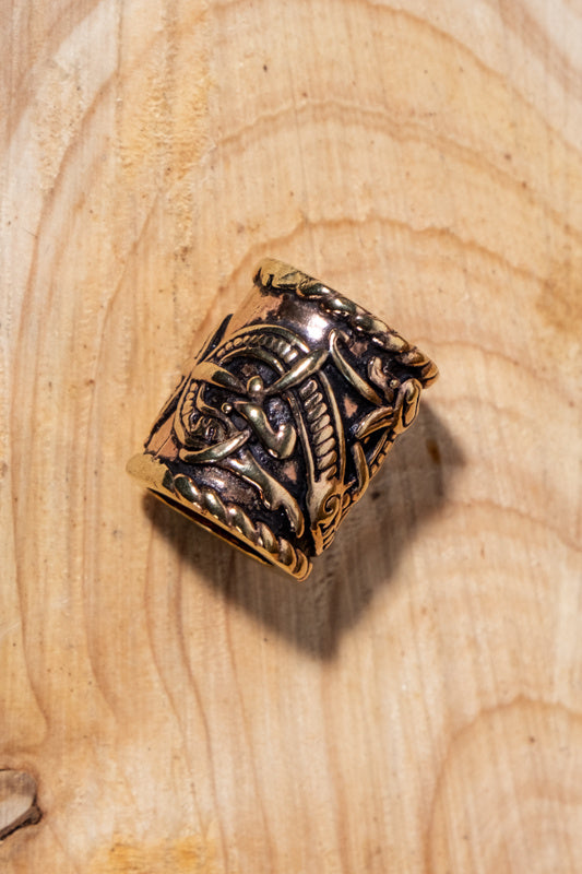 Viking beard bead with dragon motif, bronze