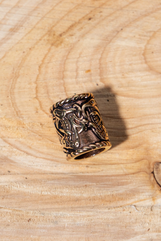 Viking beard bead with dragon motif, bronze