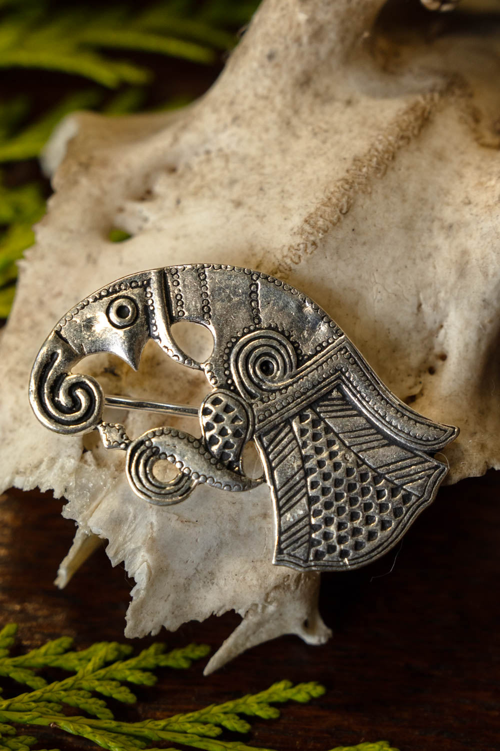 Vendel raven brooch Gotland, left, silvered bronze