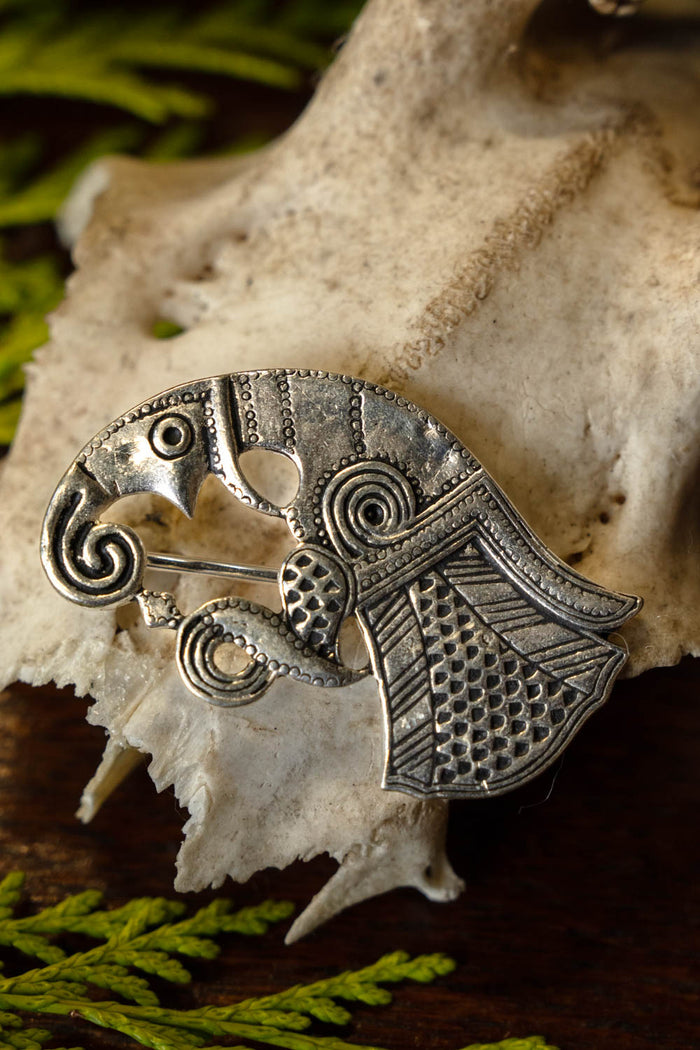 Vendel raven brooch Gotland, left, silvered bronze